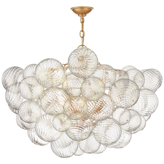 Talia Collection Light shimmers through multiple swirled glass orbs attached to metal baskets, creating a whimsical flourish. The Talia chandelier in Gild finish adds a dynamic mix of sparkling glass, rounded forms, and bright metals to any interior.